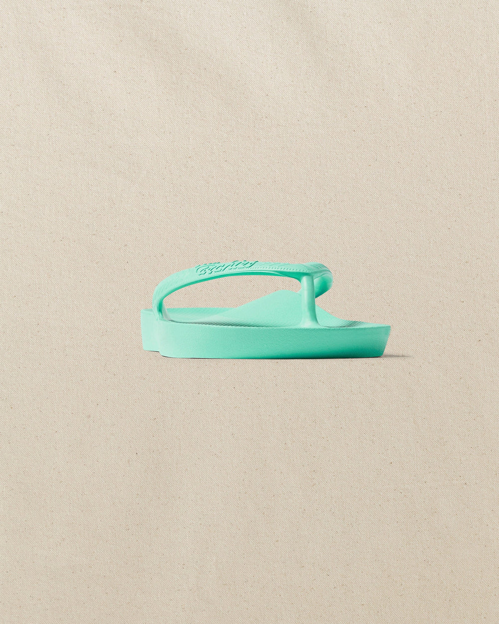 The front side view of the Southern Tide Archies Mint Arch Support Flip Flop by Southern Tide - Mint