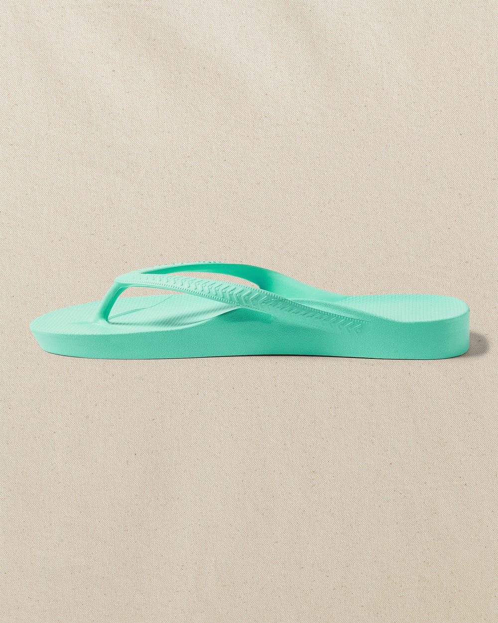 The left side view of the Southern Tide Archies Mint Arch Support Flip Flop by Southern Tide - Mint