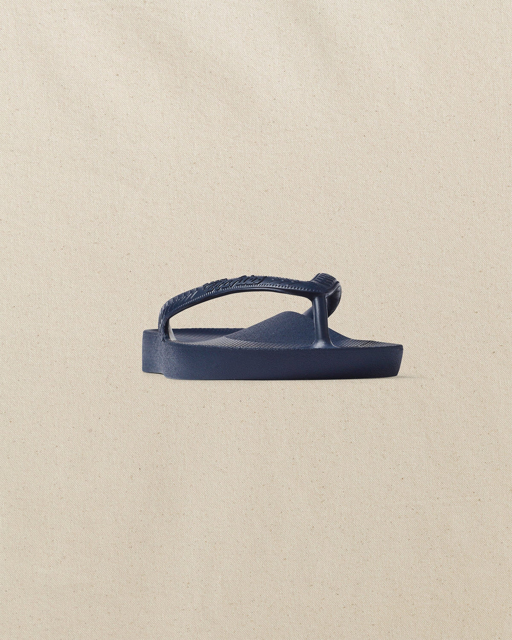 The front side view of the Southern Tide Archie's Navy Arch Support Flip Flop by Southern Tide - Navy