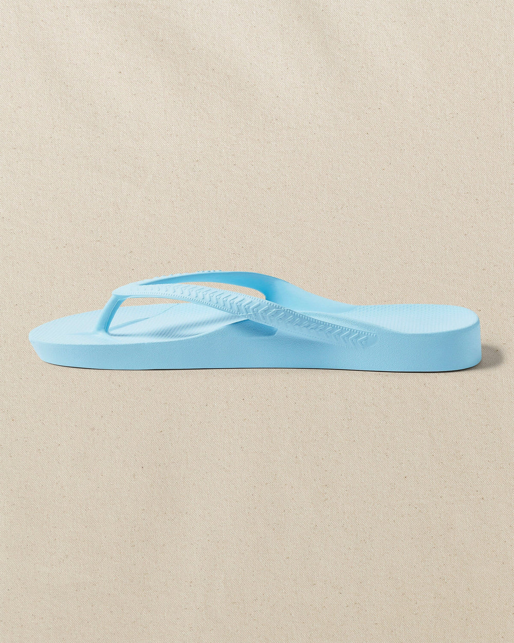 The left side view of the Southern Tide Archie's Sky Blue Arch Support Flip Flop by Southern Tide - Sky Blue