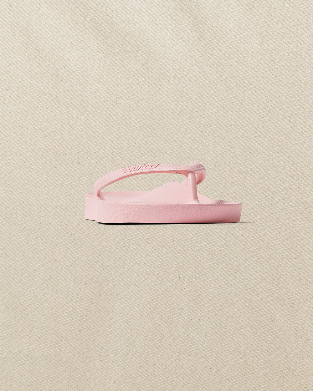 The front side view of the Southern Tide Archie's Soft Pink Arch Support Flip Flop by Southern Tide - Soft Pink