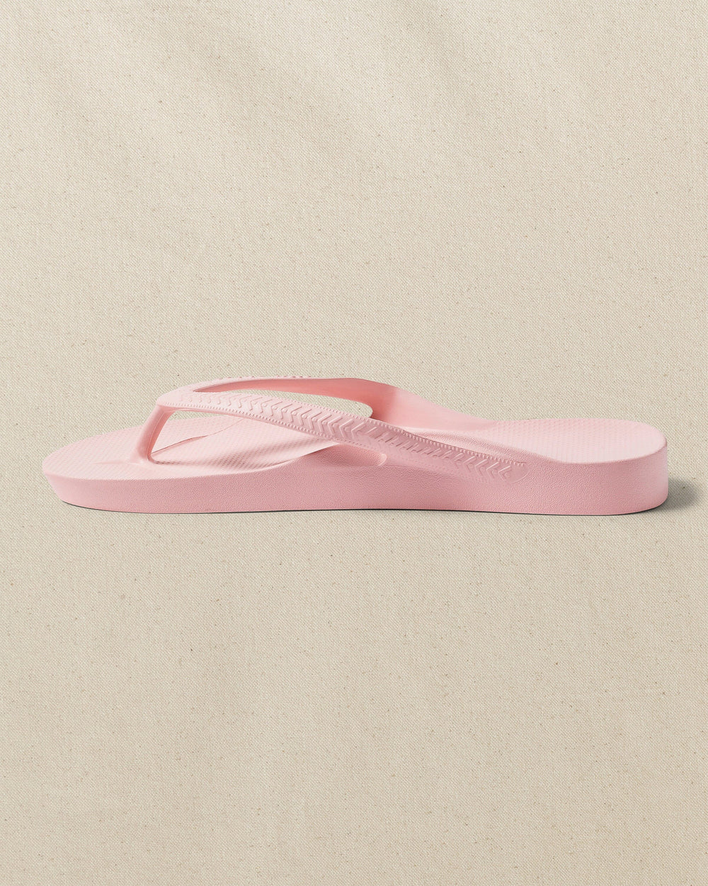 The left side view of the Southern Tide Archie's Soft Pink Arch Support Flip Flop by Southern Tide - Soft Pink
