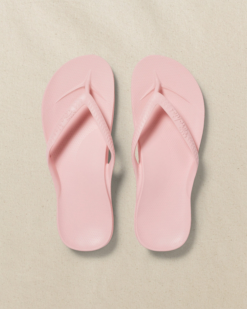 The top view of the Southern Tide Archie's Soft Pink Arch Support Flip Flop by Southern Tide - Soft Pink