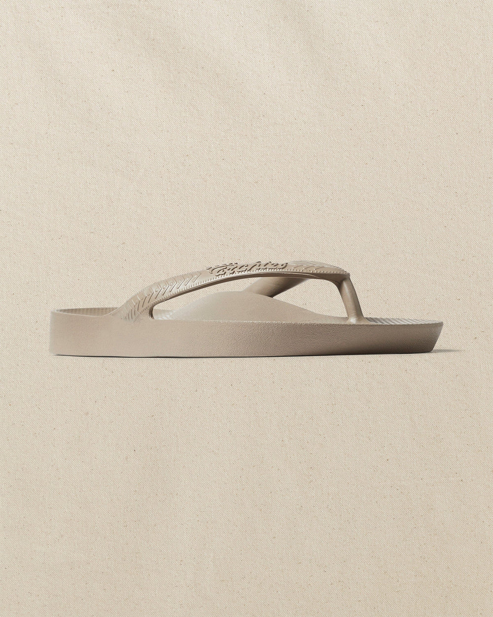 The right angle view of the Southern Tide Archie's Taupe Arch Support Flip Flop by Southern Tide - Taupe