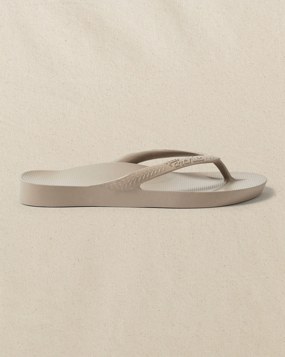The right side view of the Southern Tide Archie's Taupe Arch Support Flip Flop by Southern Tide - Taupe