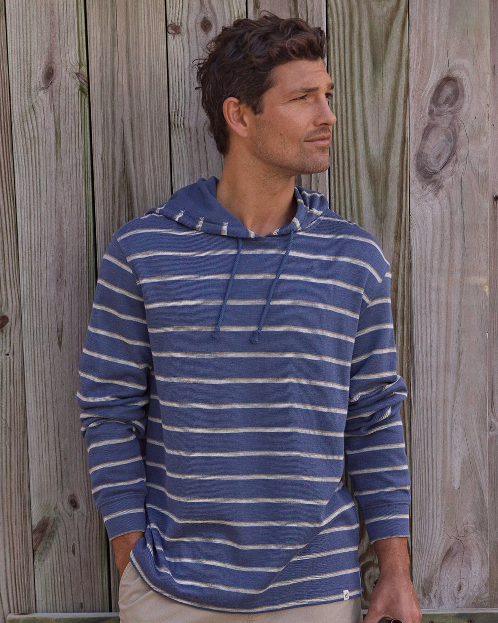 The lifestyle view of the Southern Tide Bay View Stripe Hoodie by Southern Tide - Light Indigo