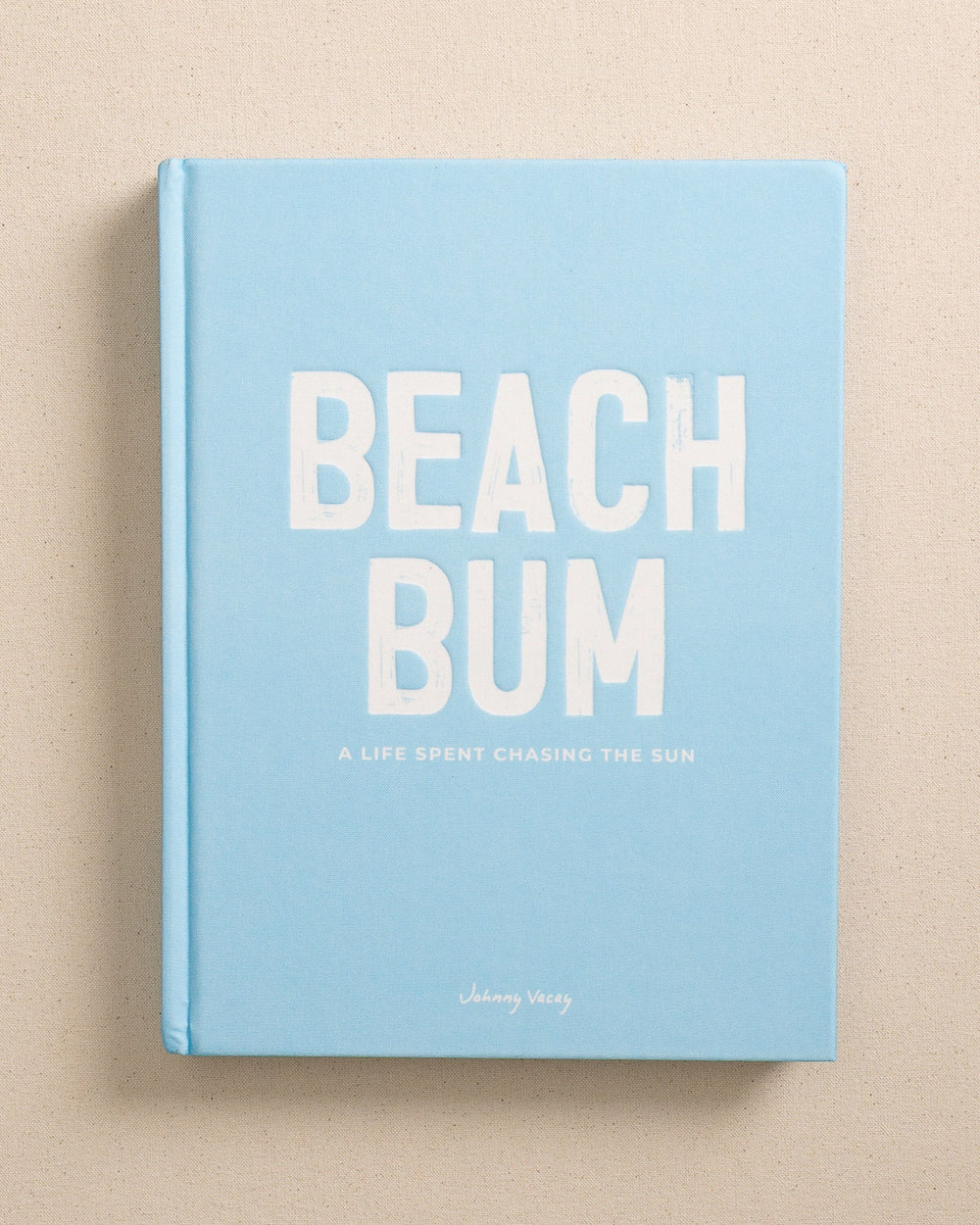 The front view of the Johnny Vacay Beach Bum Book at Southern Tide - White