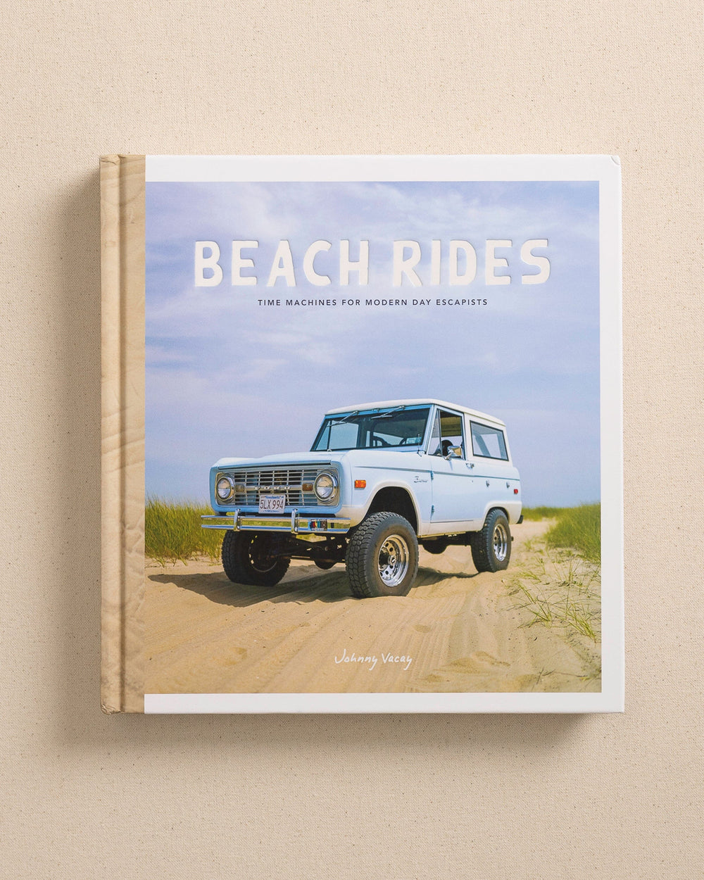 The front view of the Johnny Vacay Beach Rides Coffee Table Book at Southern Tide - White