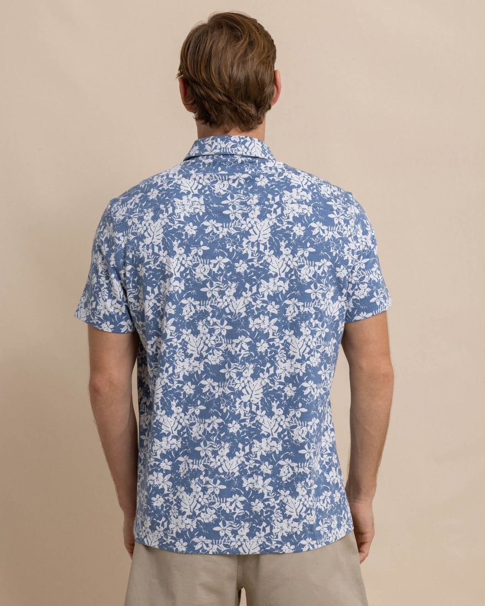 The back view of the Southern Tide Beachcast Island Blooms Knit Short Sleeve Sport Shirt by Southern Tide - Coronet Blue