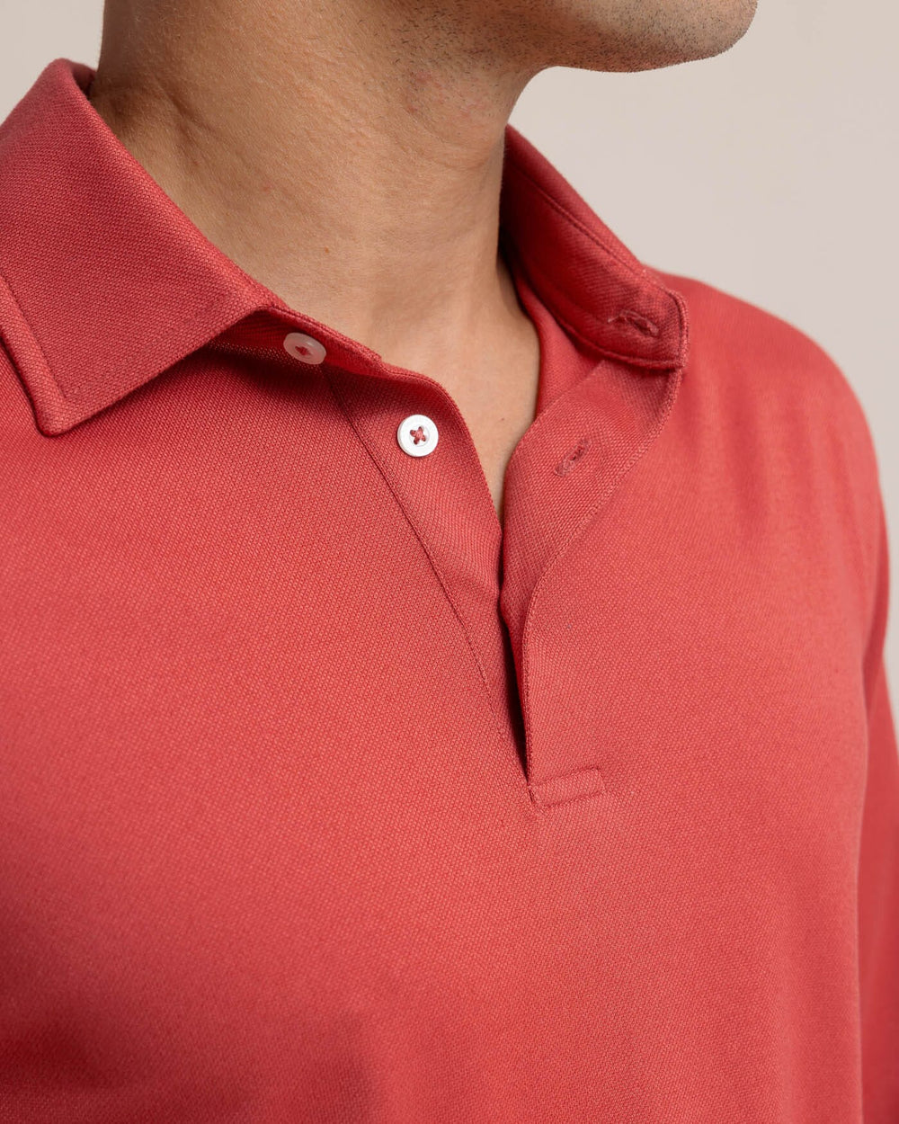 The detail view of the Southern Tide Belfair Performance Long Sleeve Polo by Southern Tide - Mineral Red