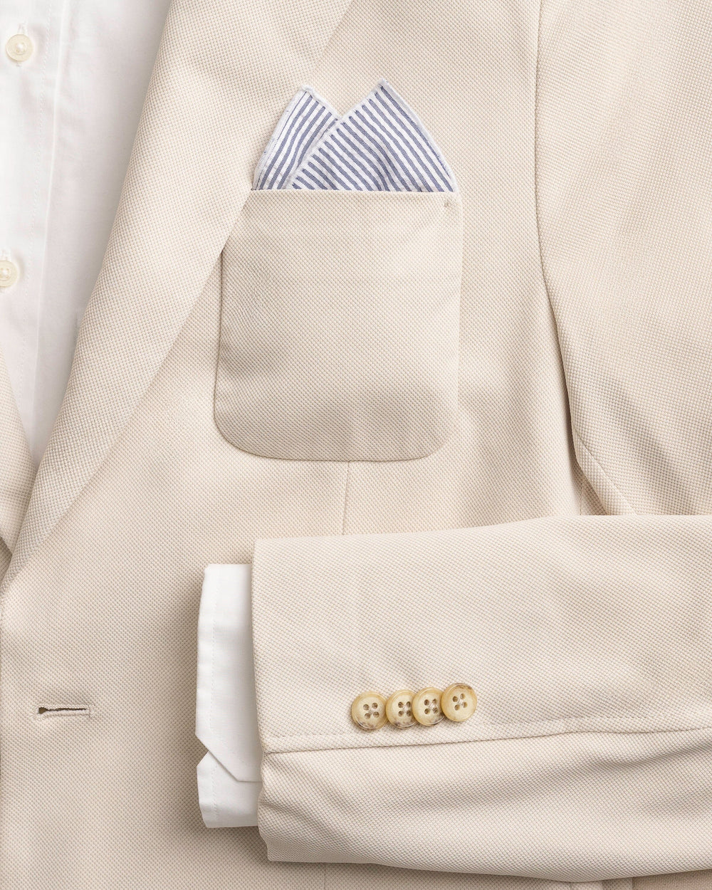The detail coat view of the Southern Tide Blue and White Seersucker Pocket Square by Southern Tide - Blue