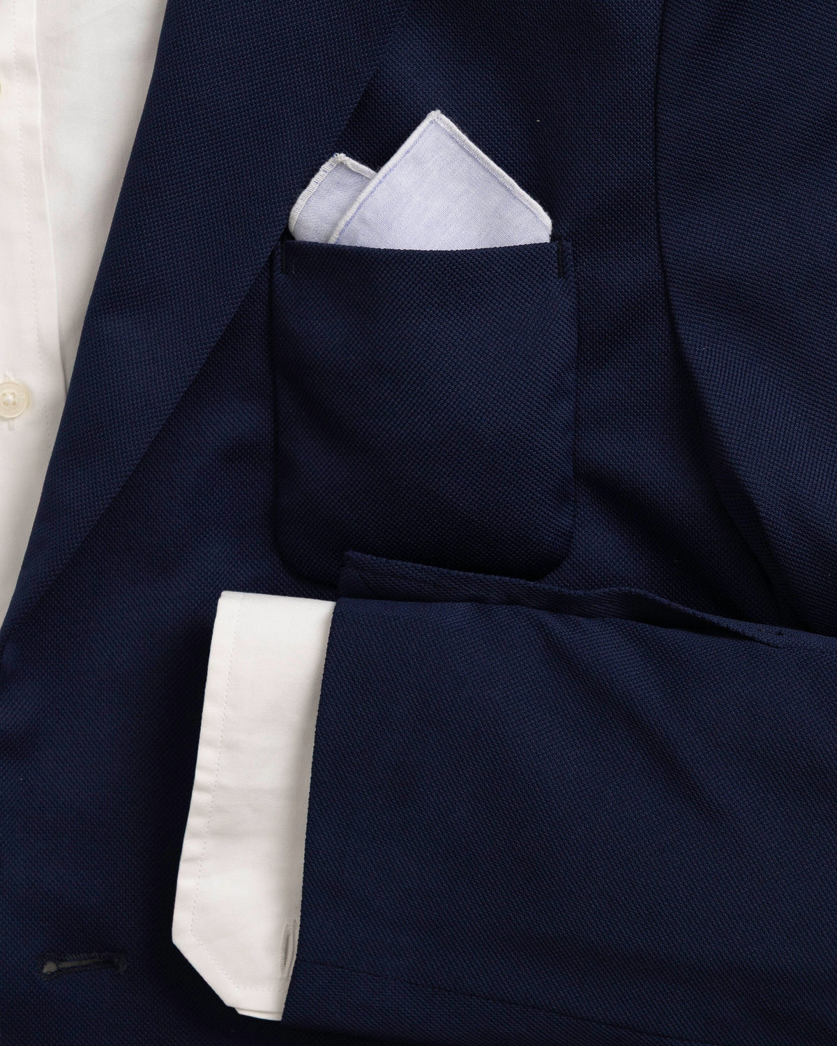 The detail coat view of the High Cotton Blue Chambray Pocket Square at Southern Tide - Blue