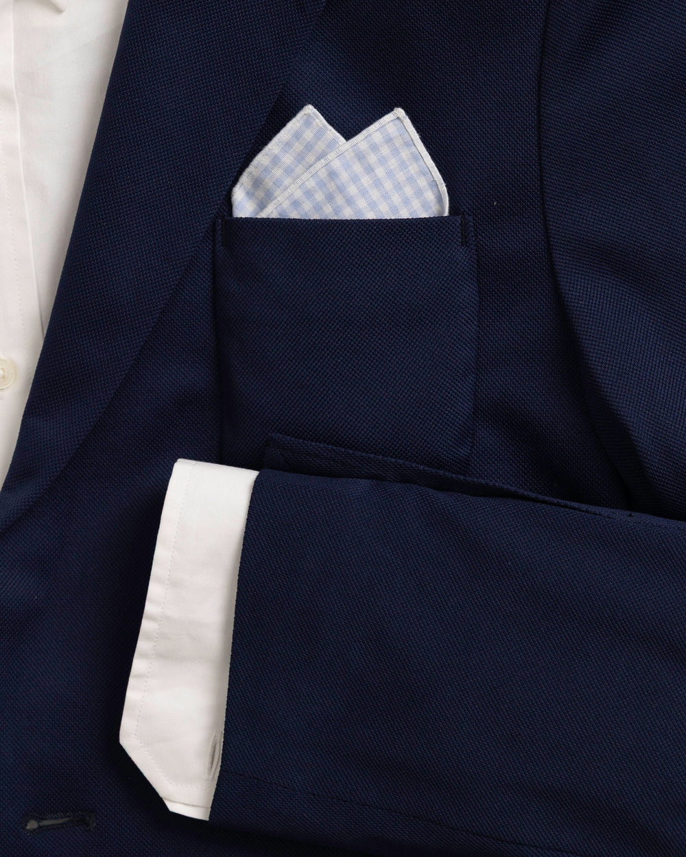 The detail coat view of the High Cotton Blue Gingham Pocket Square at Southern Tide - Blue