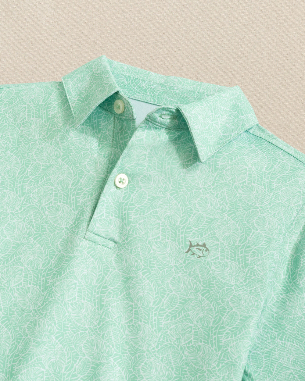 The detail view of the Southern Tide Boys Driver Beach Palms Printed Performance Polo by Southern Tide - Garden Grove