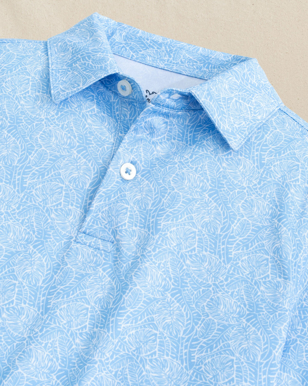 The detail view of the Southern Tide Boys Driver Beach Palms Printed Performance Polo by Southern Tide - Ocean Channel
