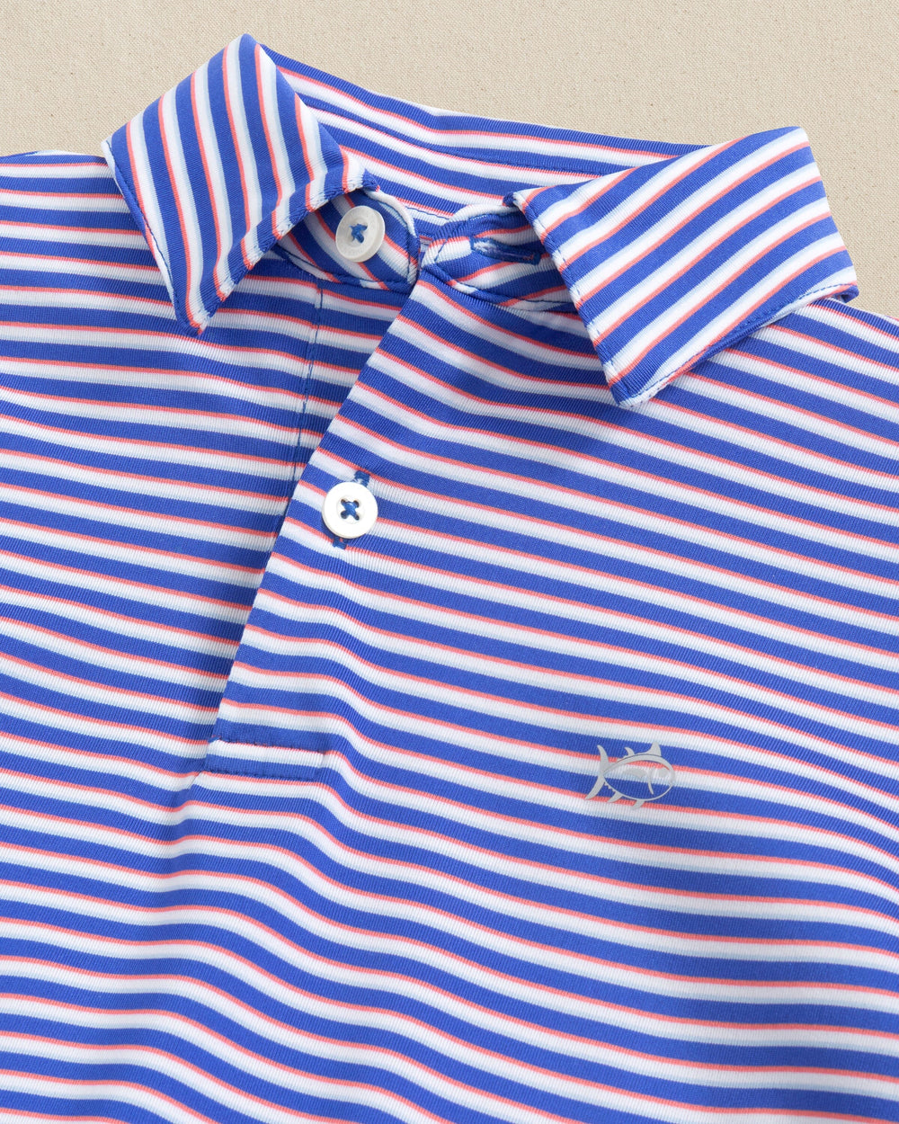 The collar detail view of the Southern Tide Kids Driver Caravel Stripe Performance Polo by Southern Tide - Dazzling Blue