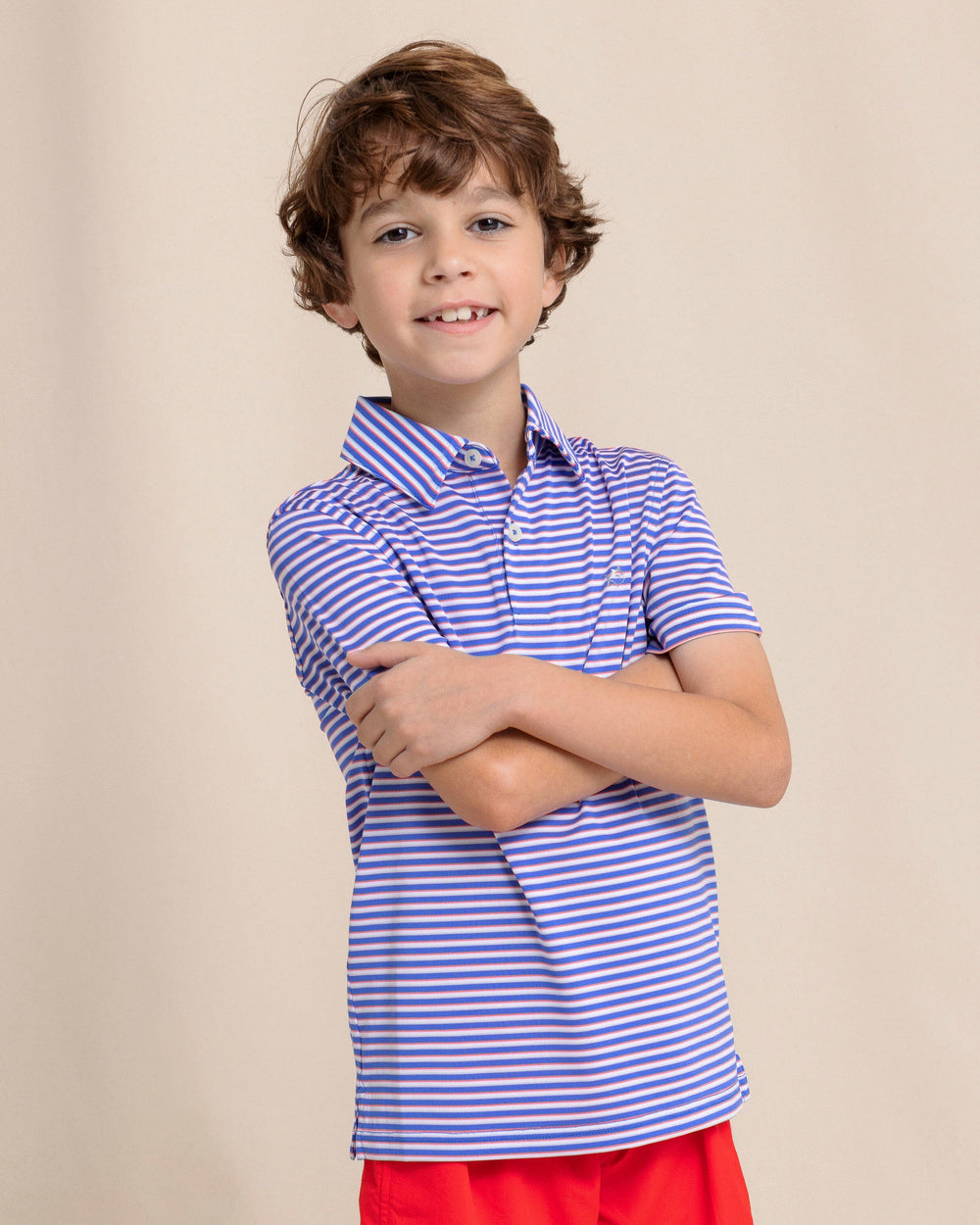 The front view of the Southern Tide Kids Driver Caravel Stripe Performance Polo by Southern Tide - Dazzling Blue
