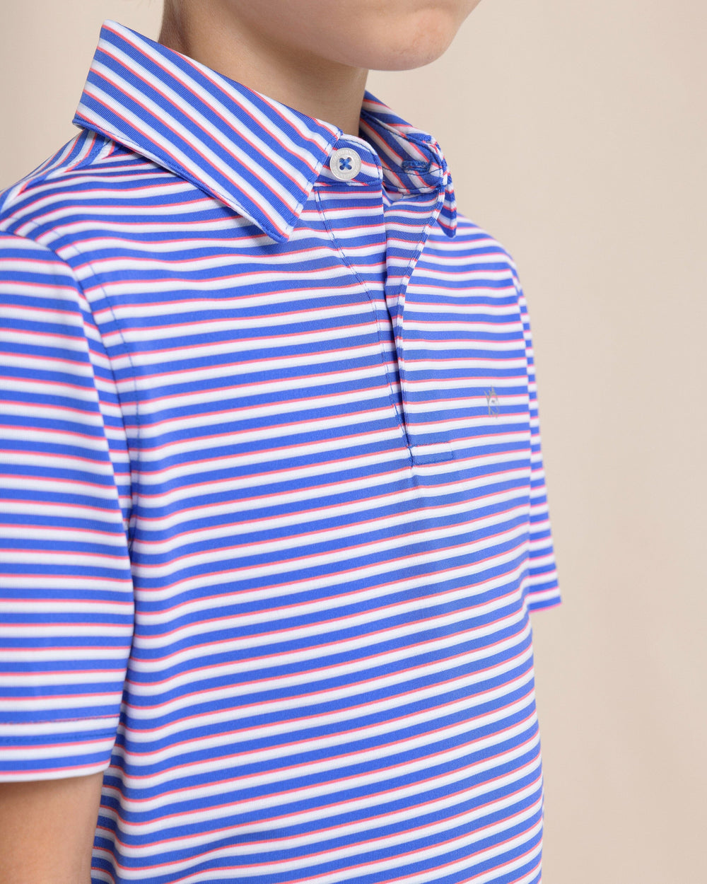 The front detail view of the Southern Tide Kids Driver Caravel Stripe Performance Polo by Southern Tide - Dazzling Blue