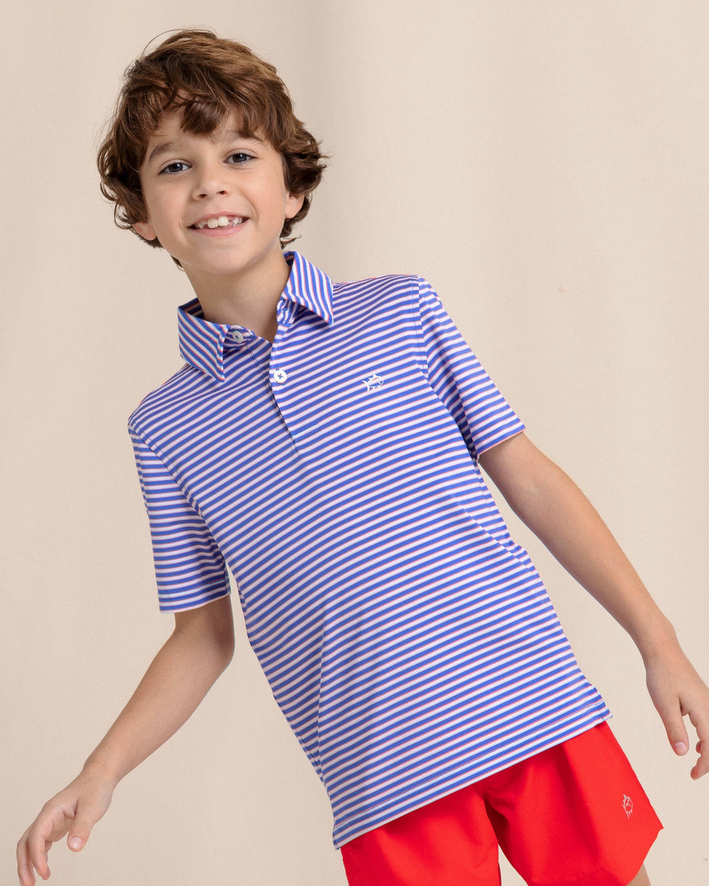 The front side view of the Southern Tide Kids Driver Caravel Stripe Performance Polo by Southern Tide - Dazzling Blue