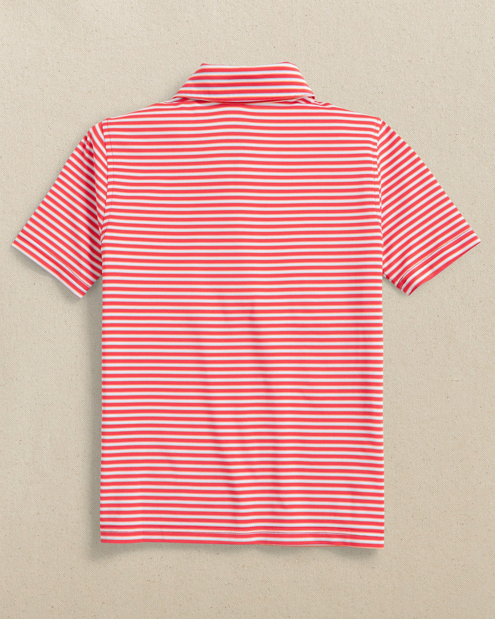 The back view of the Southern Tide Kids Driver Caravel Stripe Performance Polo by Southern Tide - Poppy Red
