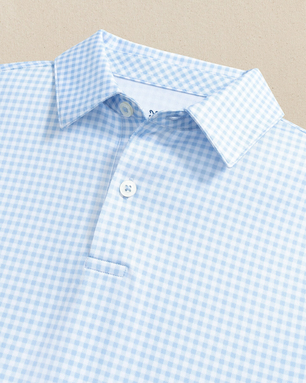 The detail view of the Southern Tide Boys Driver Gingham Printed Performance Polo by Southern Tide - Tide Blue