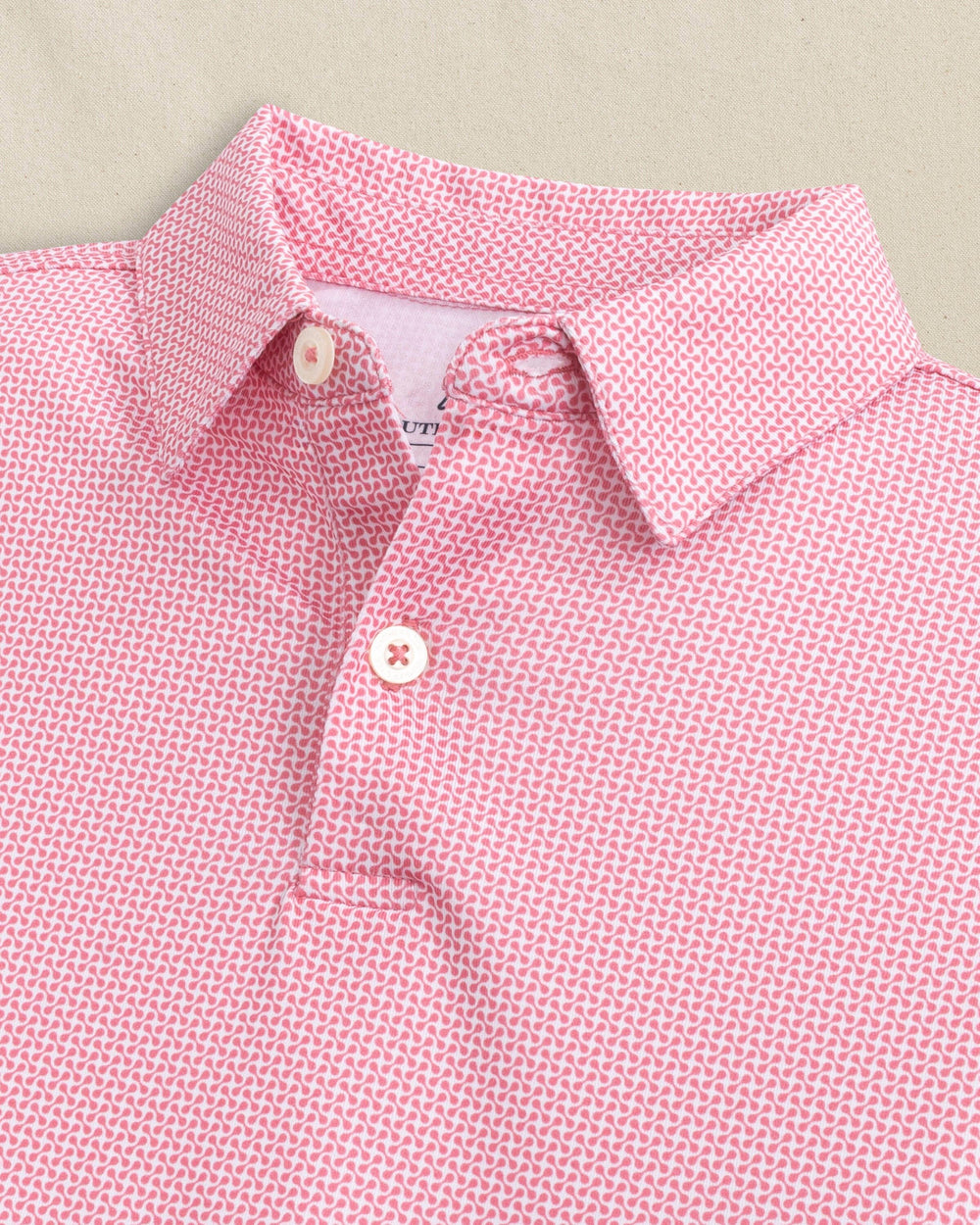 The detail view of the Southern Tide Boys Driver Ocean Vista Printed Performance Polo by Southern Tide - Island Pink
