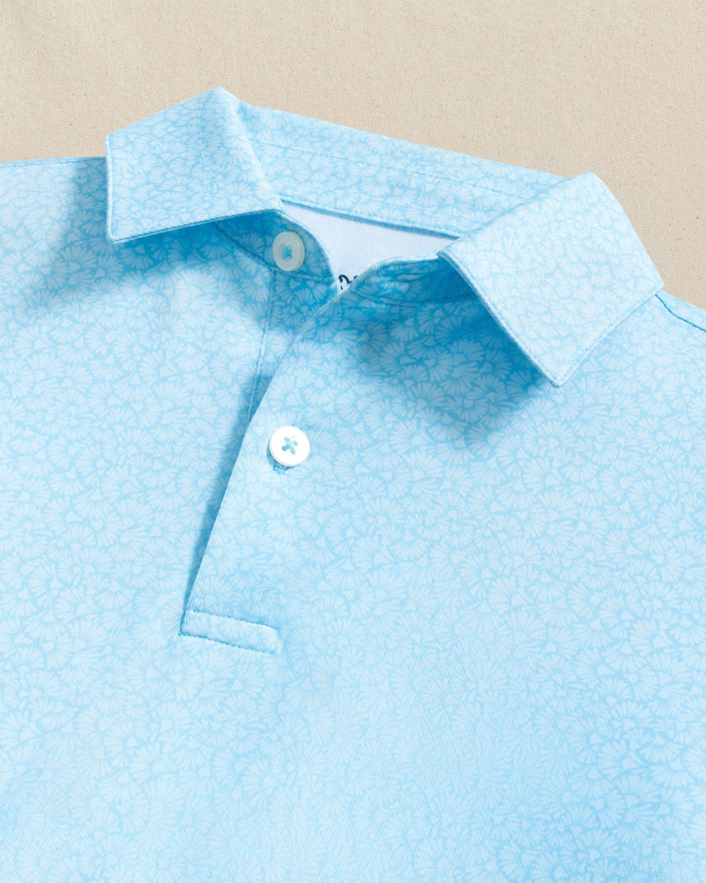 The detail view of the Southern Tide Boys Driver Paradise Shores Printed Performance Polo by Southern Tide - Tropical Breeze Blue