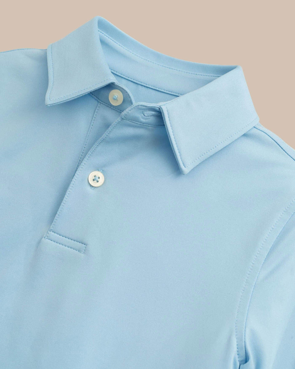 The detail view of the Boys Driver Performance Polo Shirt by Southern Tide - Sky Blue
