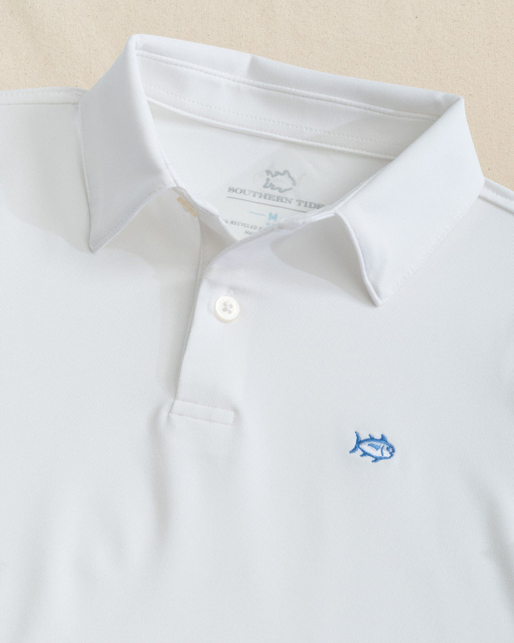 The detail view of the Southern Tide Boys Driver Performance Skipjack Polo by Southern Tide - Classic White