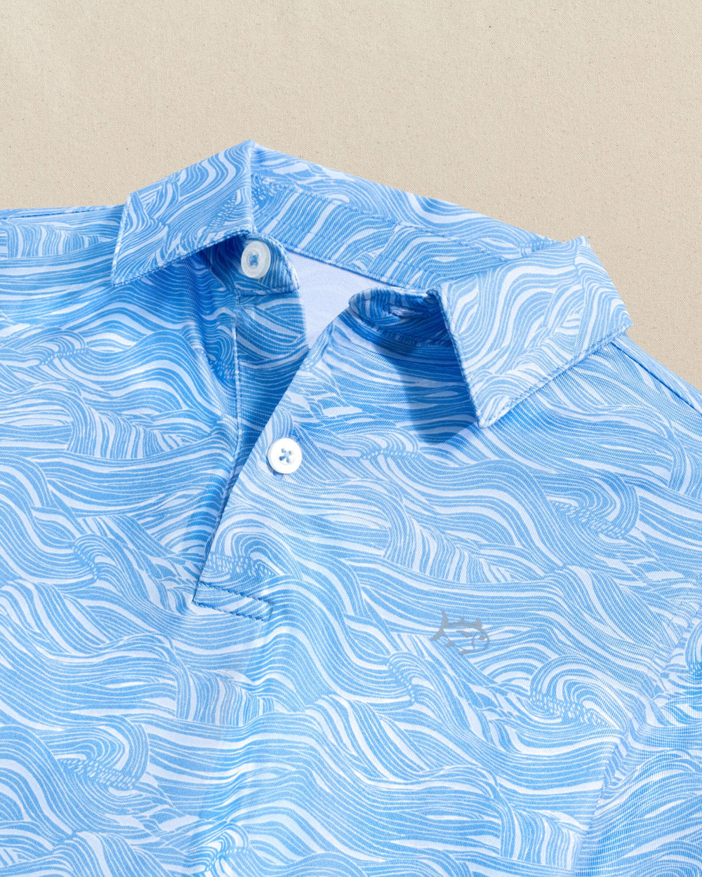 The detail view of the Southern Tide Boys Driver Rolling Waves Printed Performance Polo by Southern Tide - Boat Blue