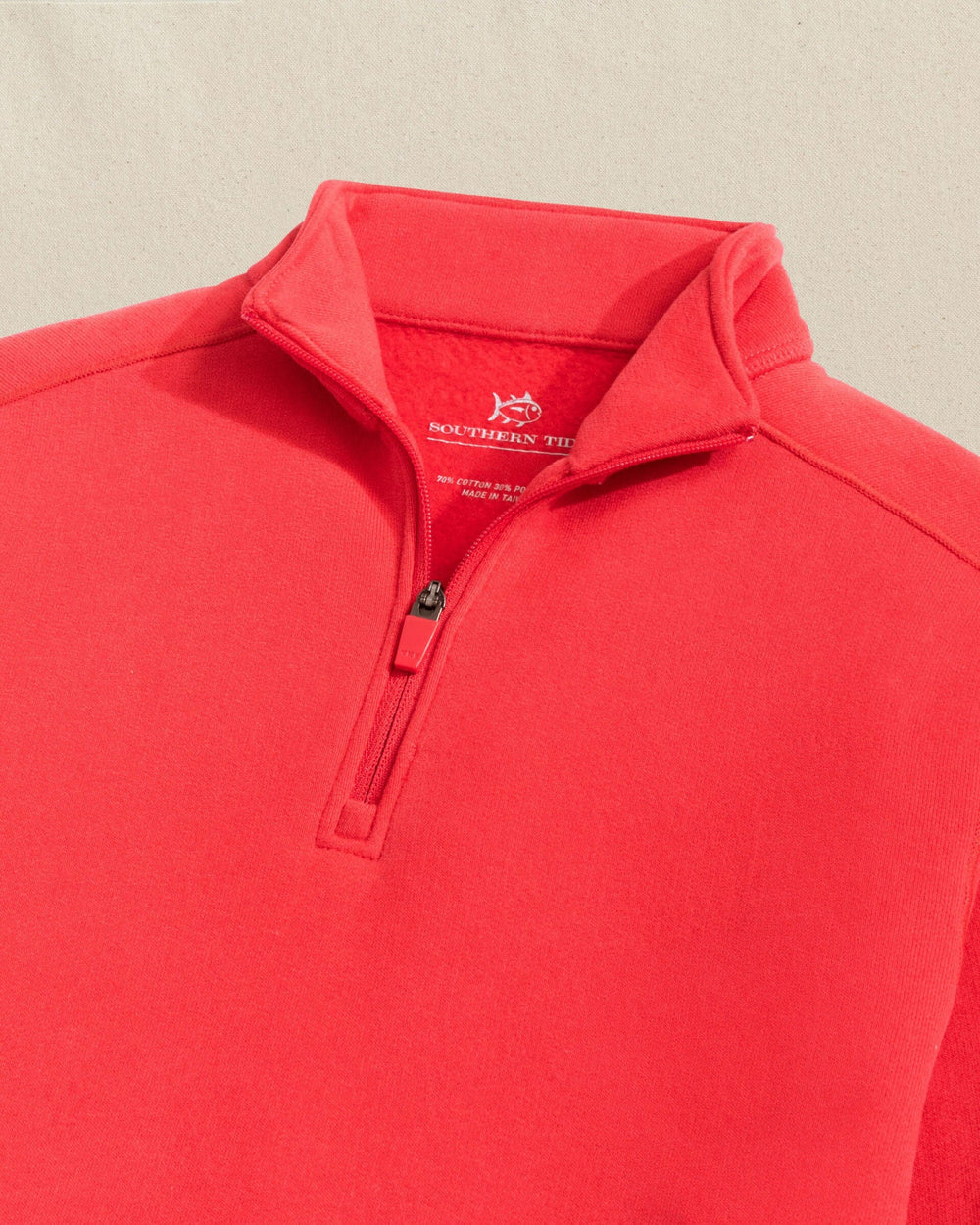 The detail view of the Southern Tide Boys Millview Fleece Quarter Zip by Southern Tide - Crab Red