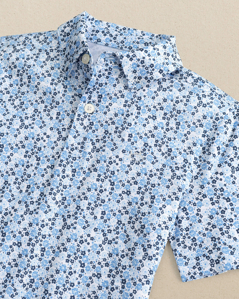 The detail view of the Southern Tide Boys Petal Party Printed Performance Polo by Southern Tide - Classic White