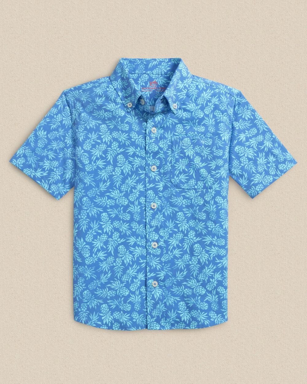 The front view of the Southern Tide Boys Pineapple Parade Coastal Breeze® Short Sleeve Sport Shirt by Southern Tide - Blue Stream