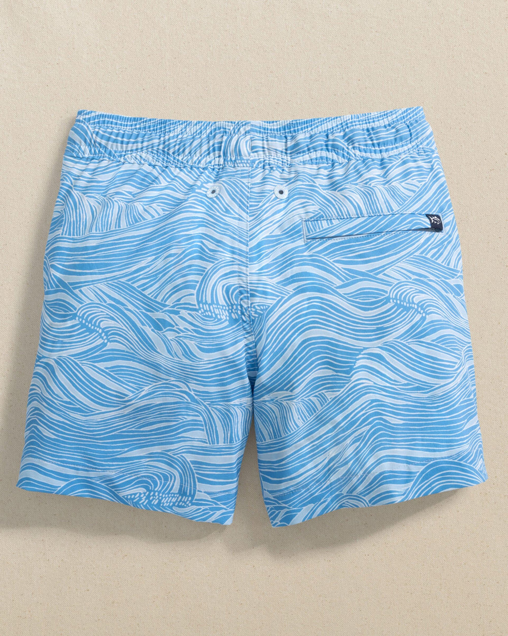 The back view of the Southern Tide Boys Rolling Waves Swim Trunk by Southern Tide - Boat Blue