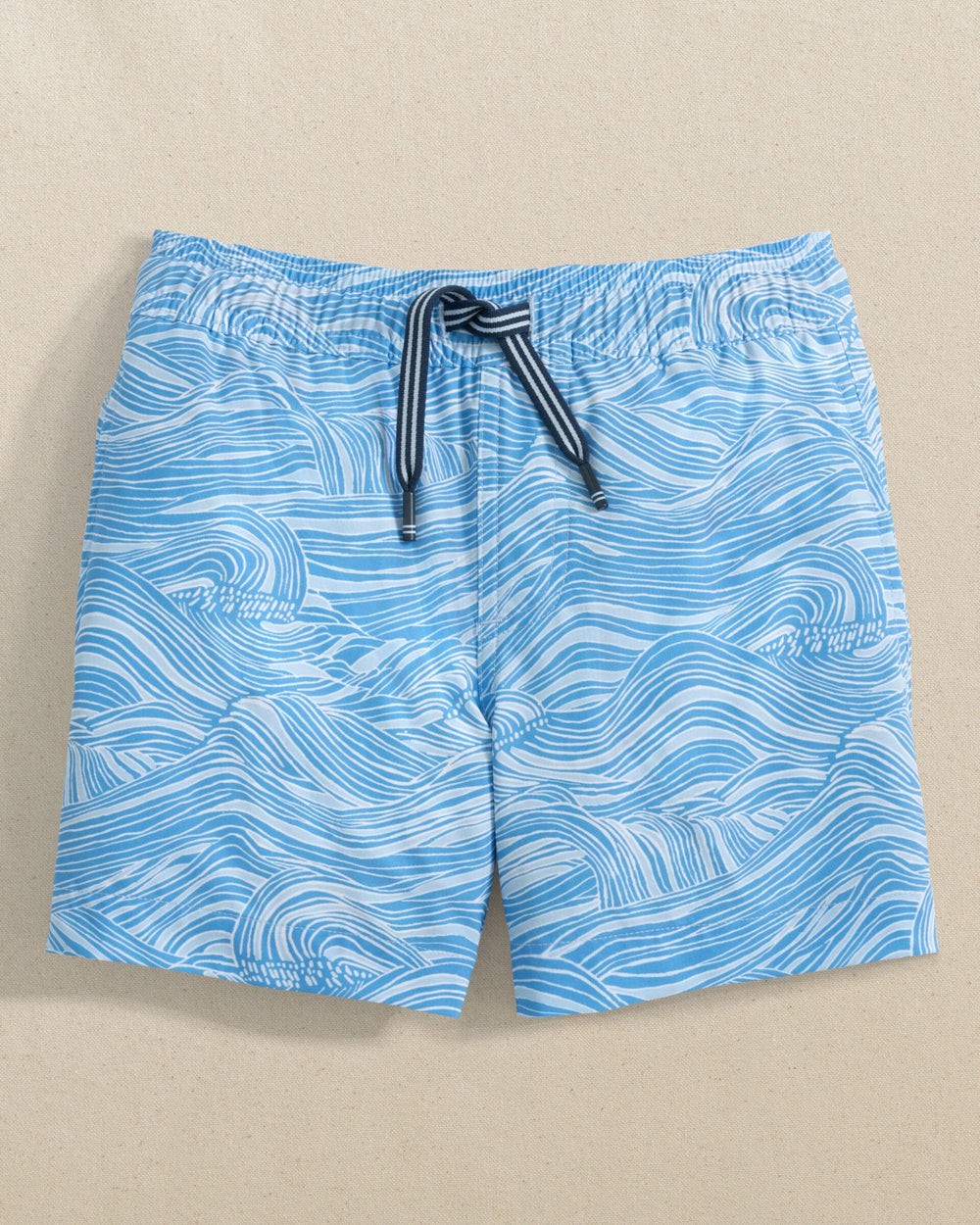 The front view of the Southern Tide Boys Rolling Waves Swim Trunk by Southern Tide - Boat Blue