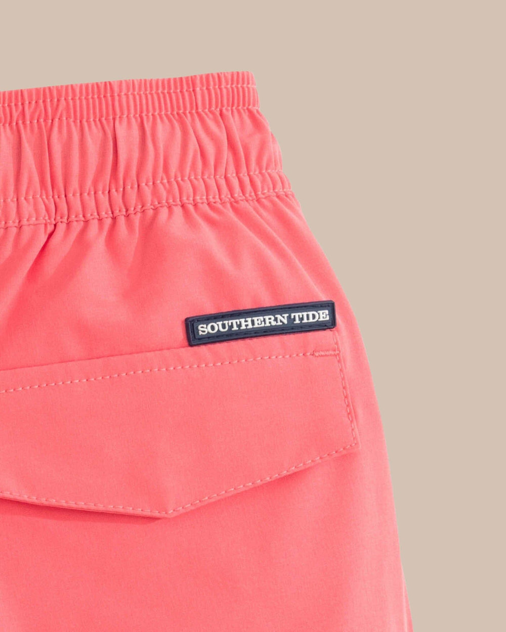 The detail view of the Southern Tide Boys Solid Swim Truck 2 0 by Southern Tide - Sunkist Coral