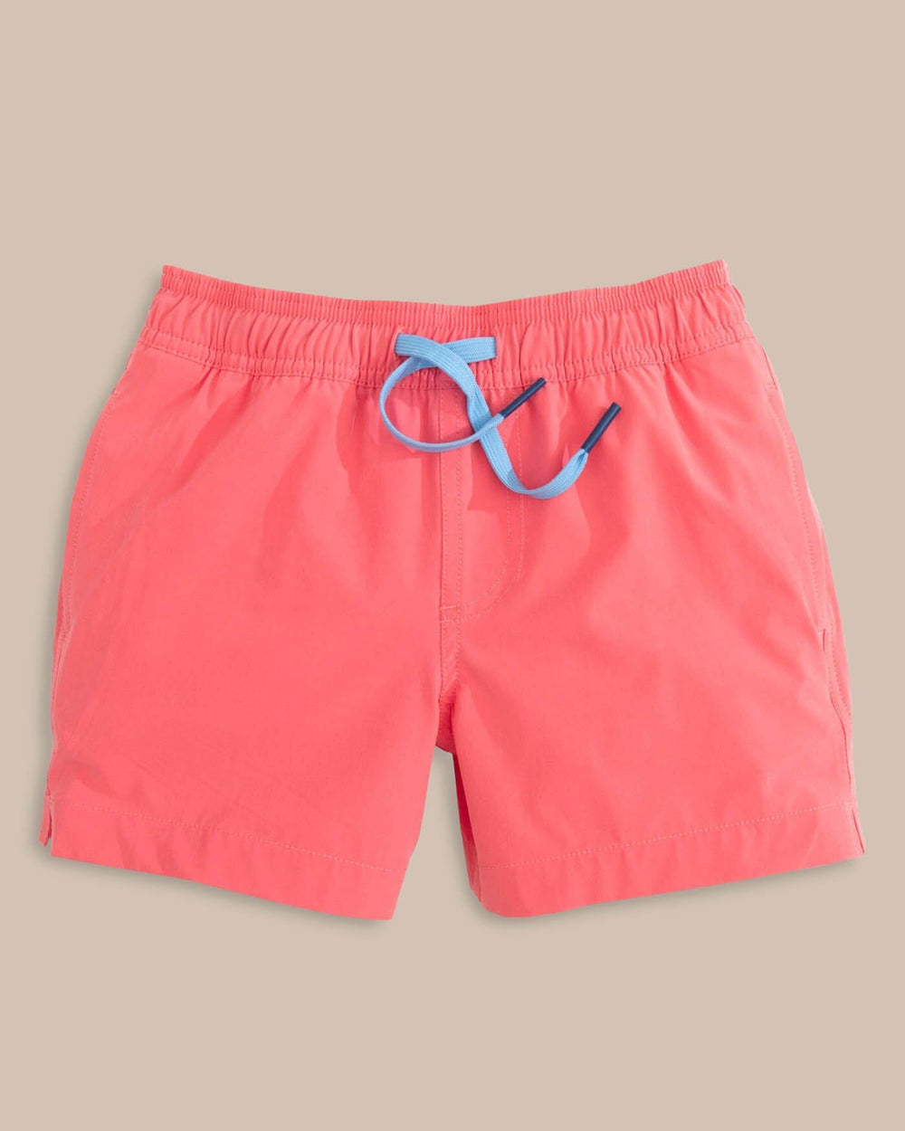 The front view of the Southern Tide Boys Solid Swim Truck 2 0 by Southern Tide - Sunkist Coral
