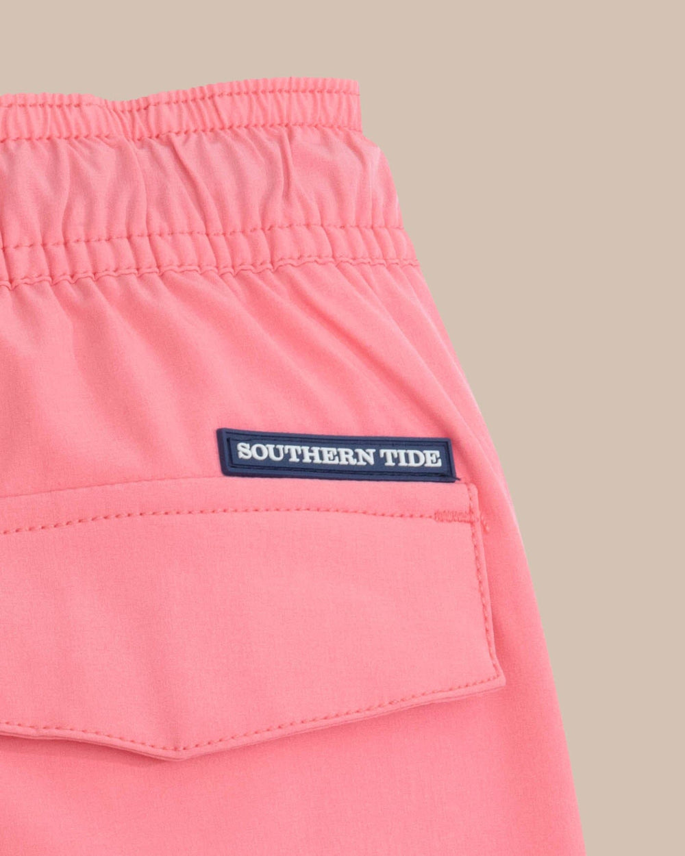 The detail view of the Southern Tide boys-solid-swim-trunk-2-1 by Southern Tide - Geranium Pink