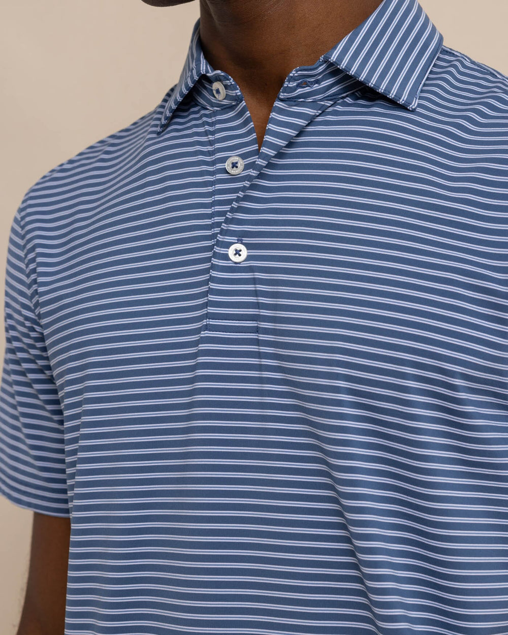 The detail view of the Southern Tide brrr eeze Beattie Stripe Performance Polo by Southern Tide - Aged Denim