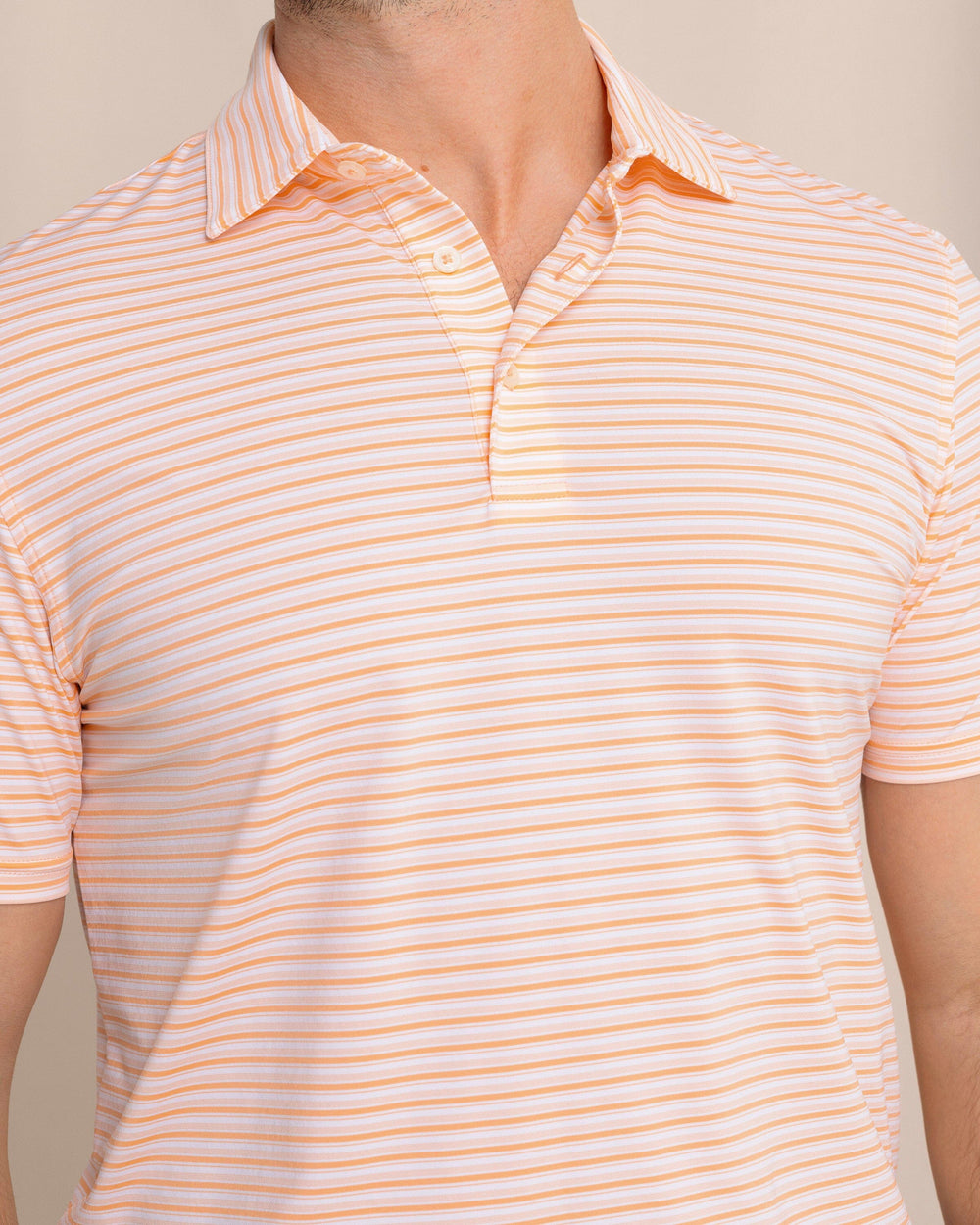 The front detail view of the Southern Tide brrr°®-eeze Breezy Point Stripe Polo by Southern Tide - Cantaloupe