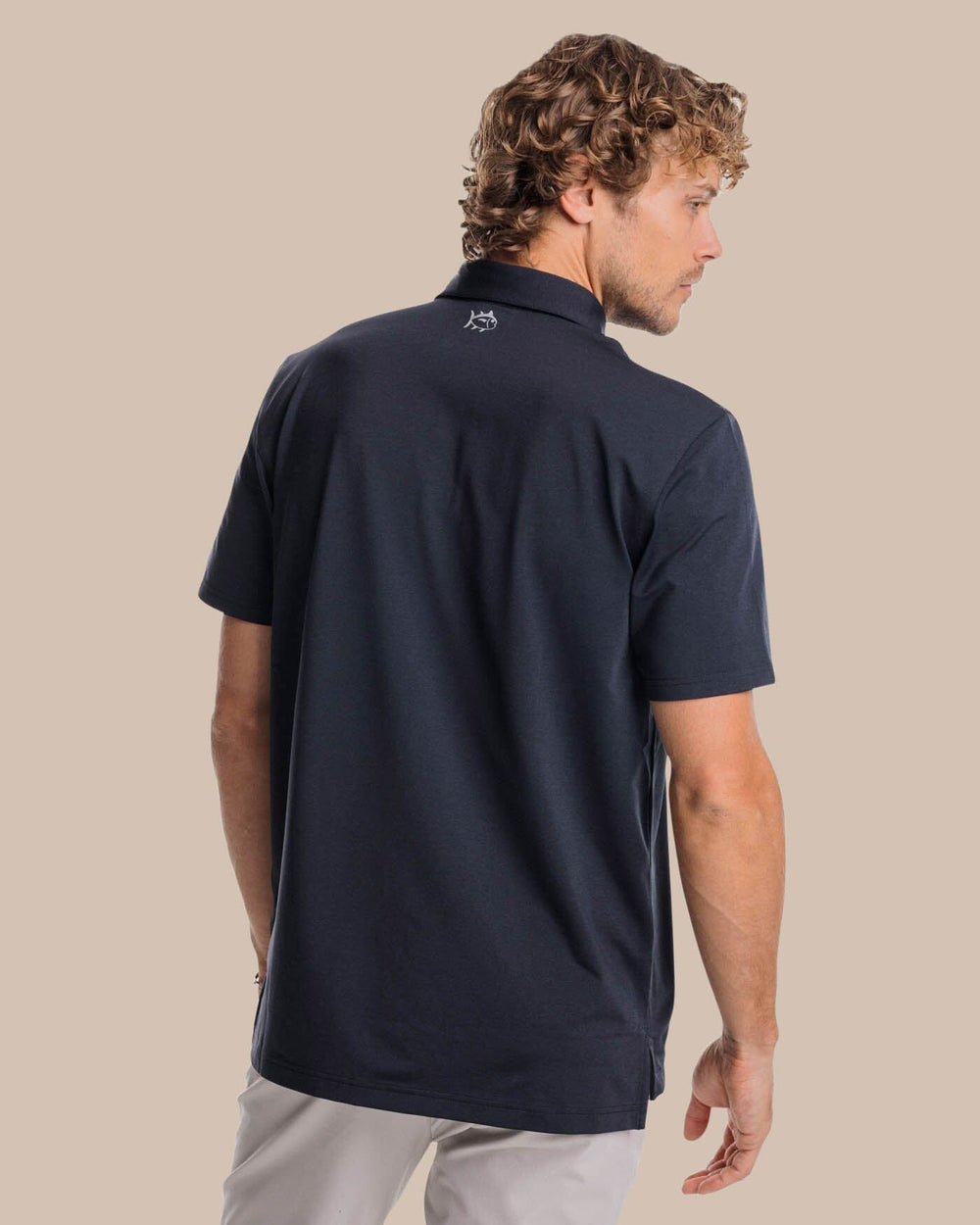 The back view of the Southern Tide brrr-eeze Heather Performance Polo Shirt by Southern Tide - Heather Caviar Black