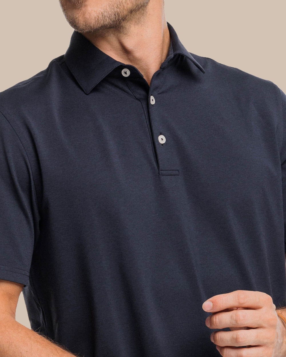 The detail view of the Southern Tide brrr-eeze Heather Performance Polo Shirt by Southern Tide - Heather Caviar Black