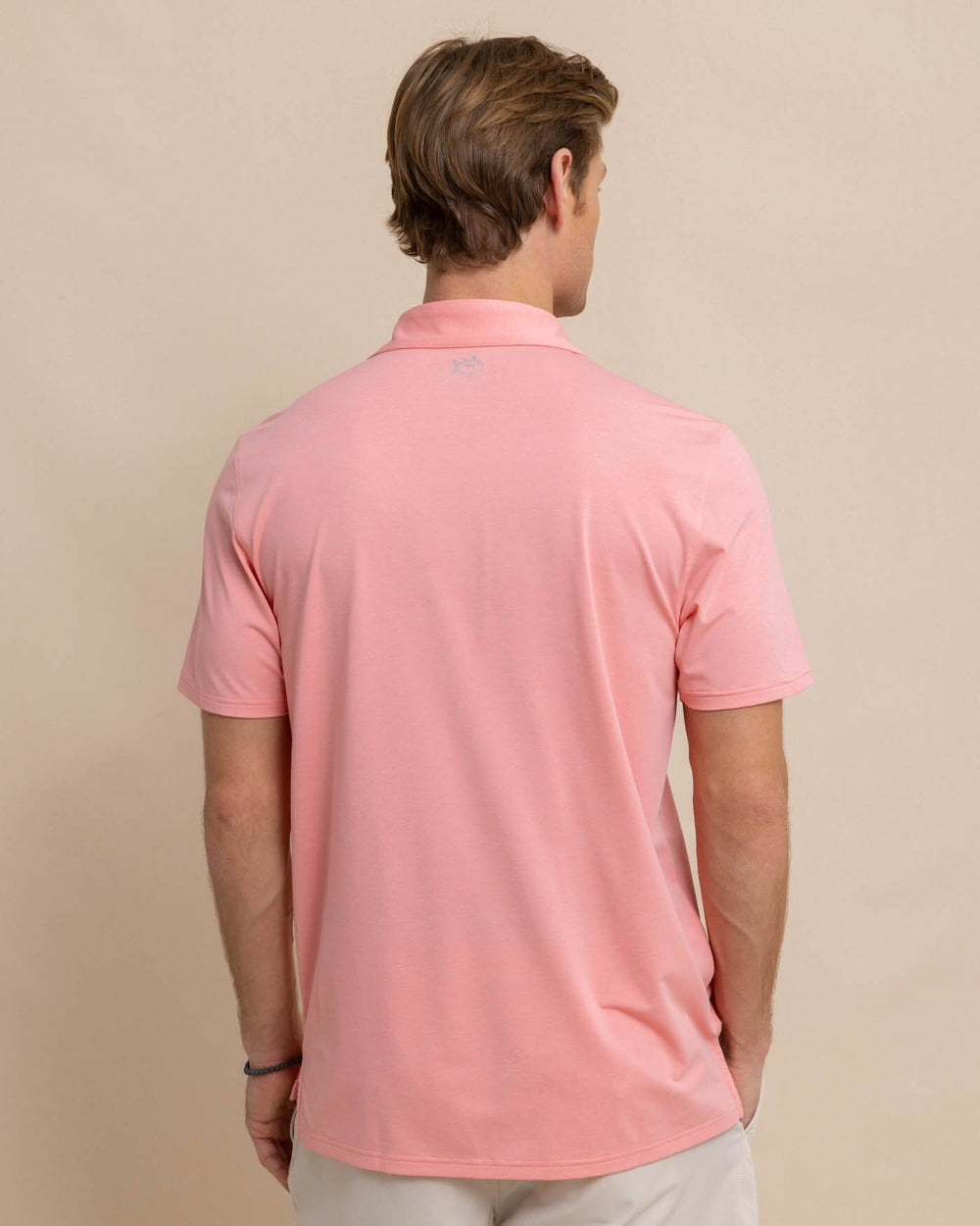 The back view of the Southern Tide brrr-eeze-heather-performance-polo-shirt by Southern Tide - Heather Flamingo Pink