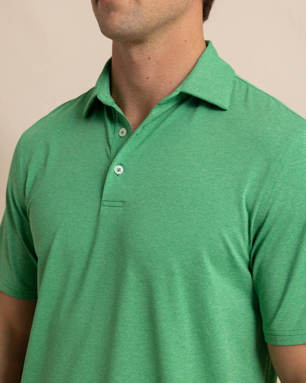 The detail view of the Southern Tide brrr-eeze-heather-performance-polo-shirt by Southern Tide - Heather Kelly Green
