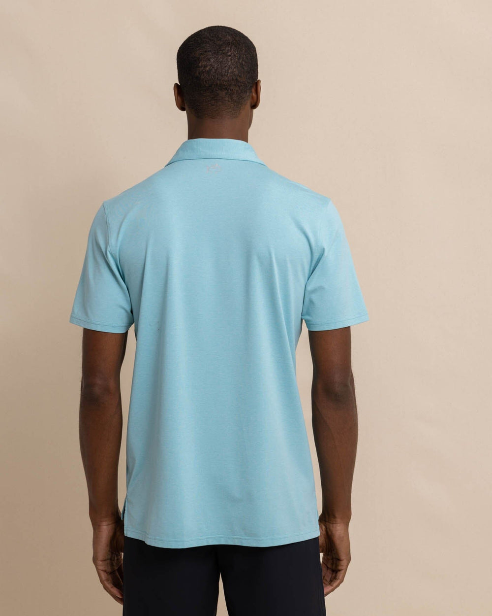 The back view of the Southern Tide brrr eeze Heather Performance Polo Shirt by Southern Tide - Heather Marine Blue