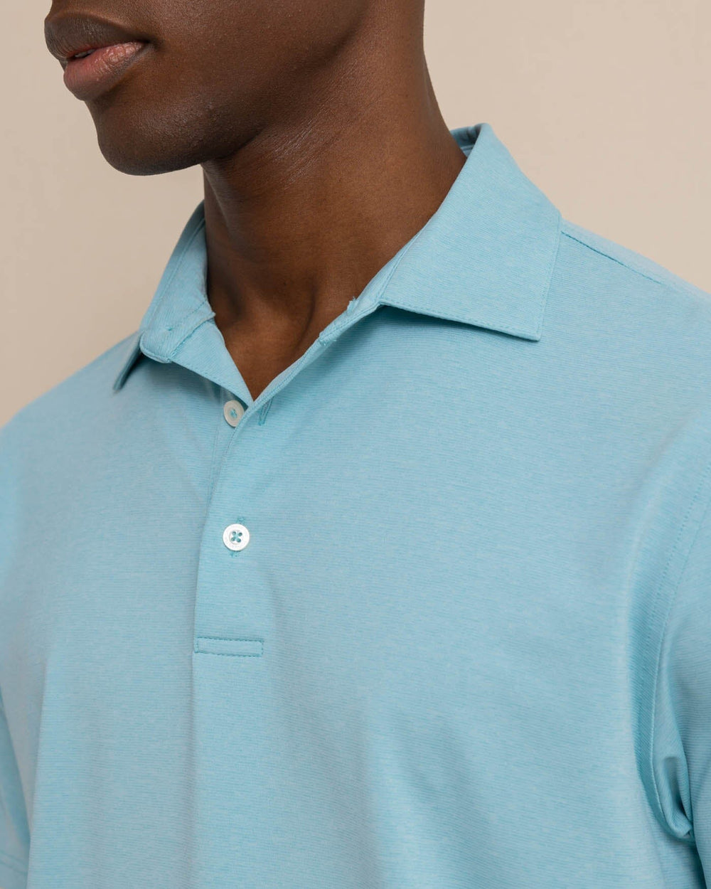 The detail view of the Southern Tide brrr eeze Heather Performance Polo Shirt by Southern Tide - Heather Marine Blue