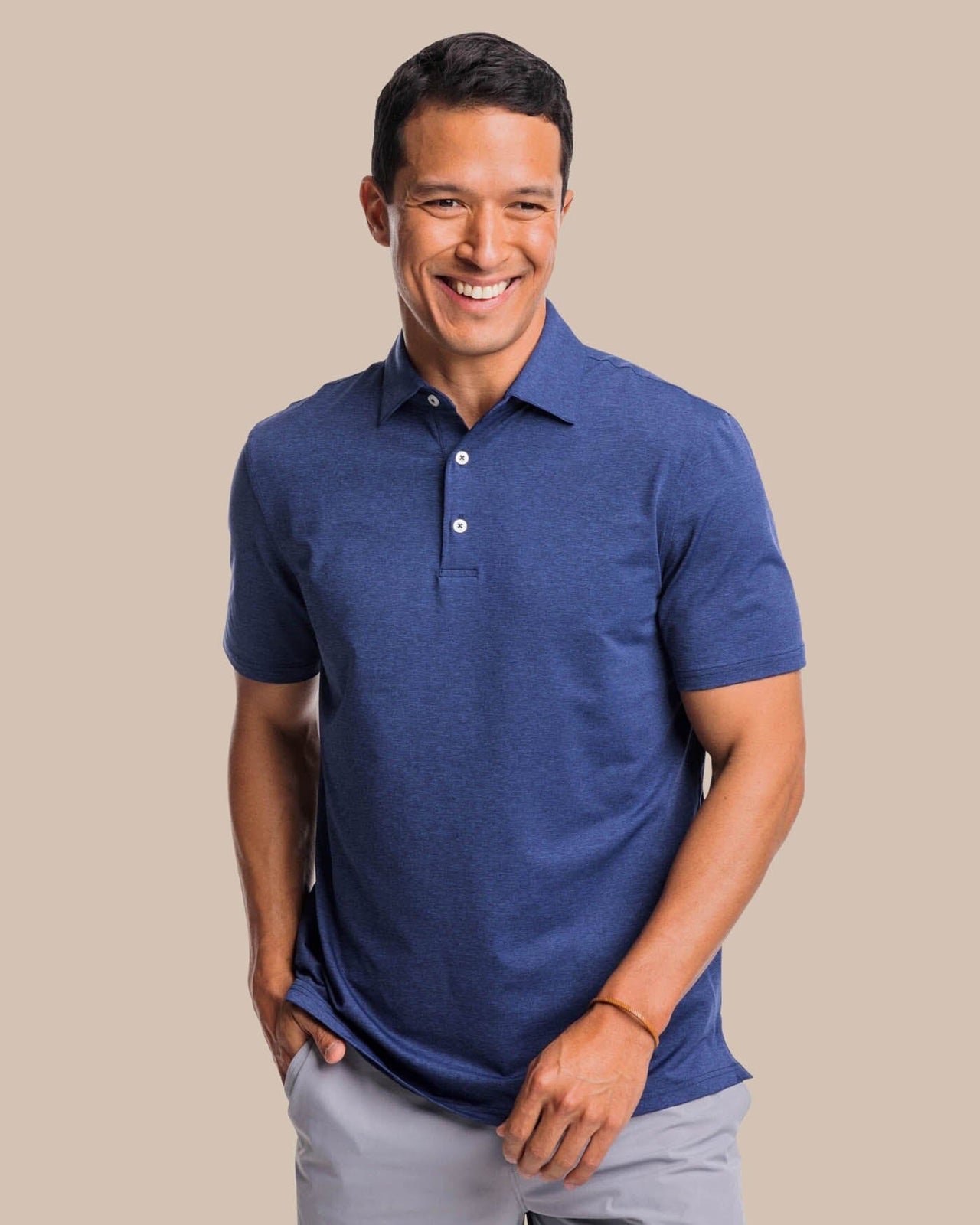 The front view of the brrr°®-eeze Heather Performance Polo Shirt by Southern Tide - Heather Nautical Navy