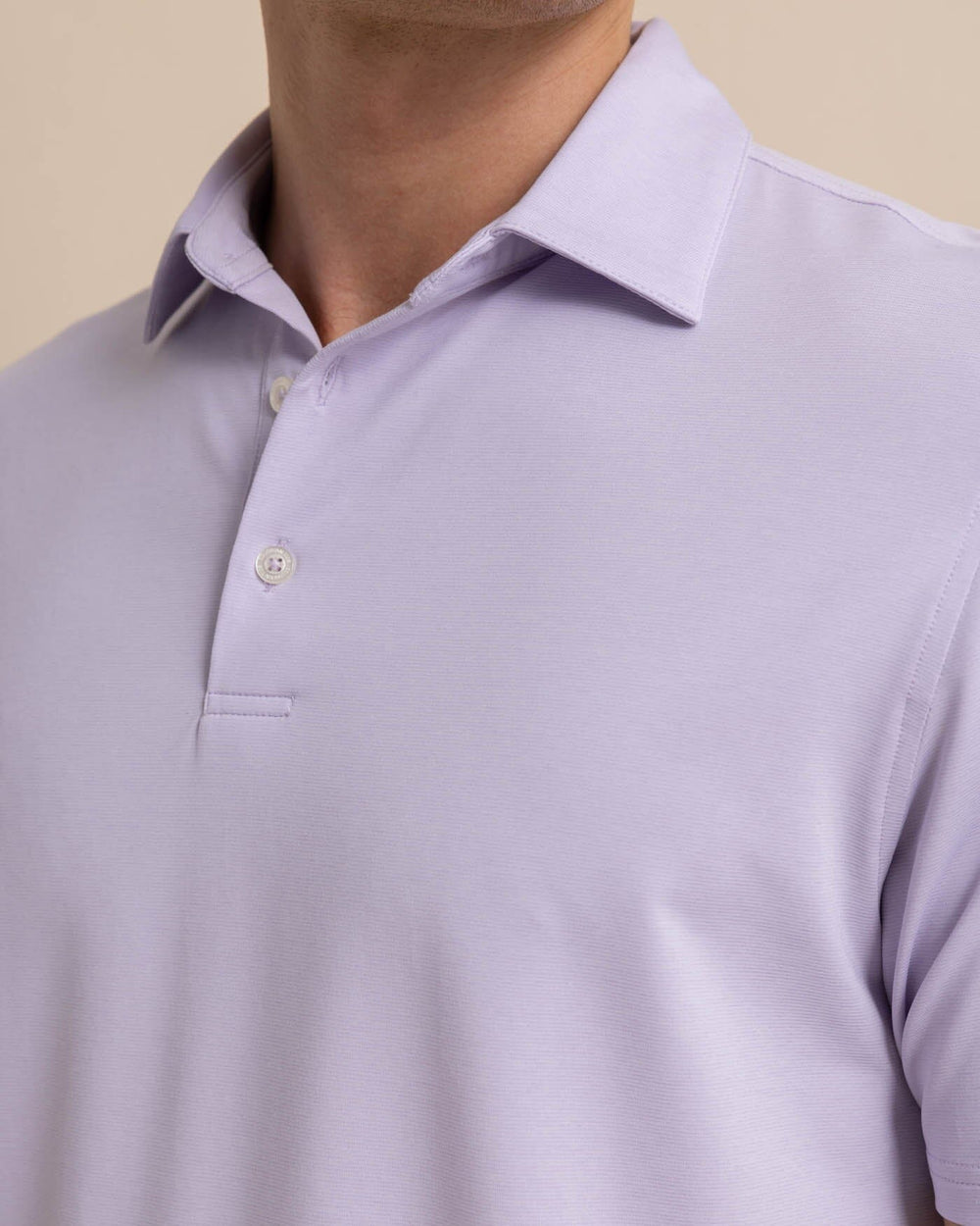 The detail view of the Southern Tide brrr eeze Heather Performance Polo Shirt by Southern Tide - Heather Orchid Petal