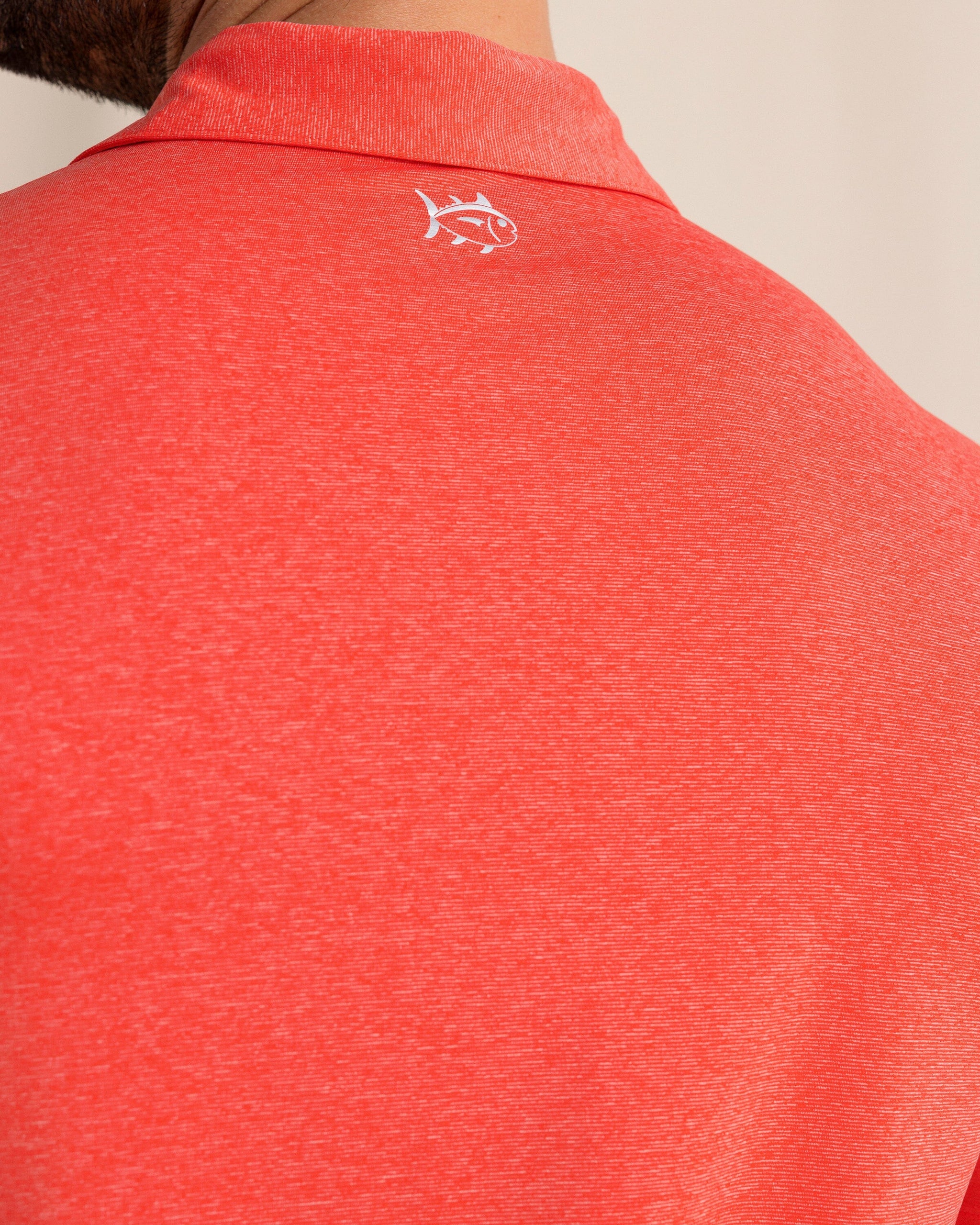 The back detail view of the Southern Tide brrr°®-eeze Heather Performance Polo Shirt by Southern Tide - Heather  Poppy Red