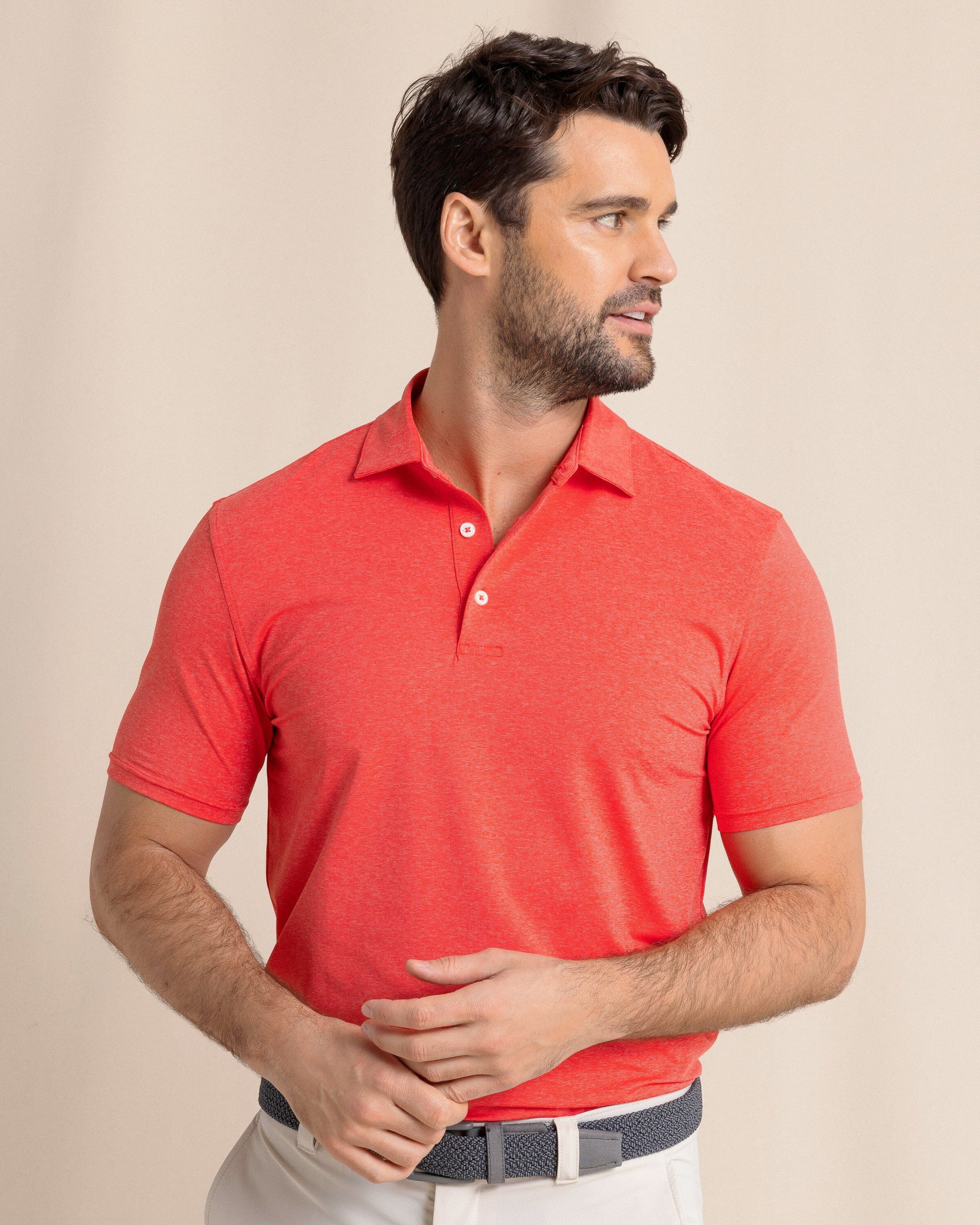 The front view of the Southern Tide brrr°®-eeze Heather Performance Polo Shirt by Southern Tide - Heather  Poppy Red